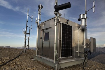 Meteorological Weather Station Building Exterior with Solar Panels and Measurement Instruments on...