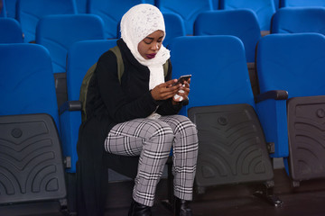 African american muslim  business womanusing phone after presentation for business people, multiracial and multiethnic business peoople at conference meeting room.