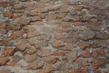 brown stone texture from old cobblestones on the sidewalk in the sand