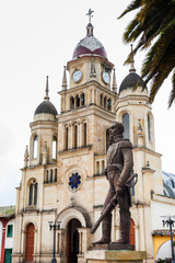 Fototapeta na wymiar Monument to Simon Bolivar and the Parish Church of the small town of Ventaquemada in Colombia