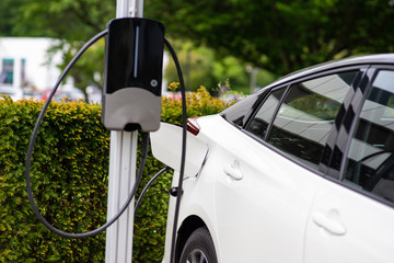 plug-in hybrid car at a charging station - 285731041