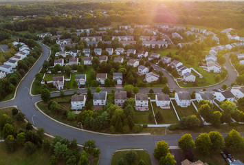 Dawn in the sleeping area of a small town with a forest on the view from a height
