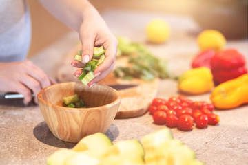 Obraz na płótnie Canvas Eat healthy. Woman is preparing a salad