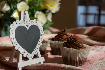 Composition of Three Chocolate Cup Cakes and a Heart-Shaped Blackboard