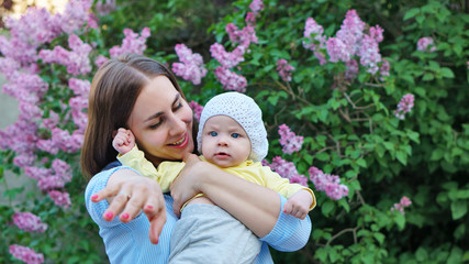 Young loving mother on maternity leave. Mother and cute toddler daughter enjoy a walk. Happiness to...