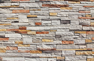 Multi-colored Red, yellow, orange and white colorful stone wall background Texture in Kusadasi, Turkey.