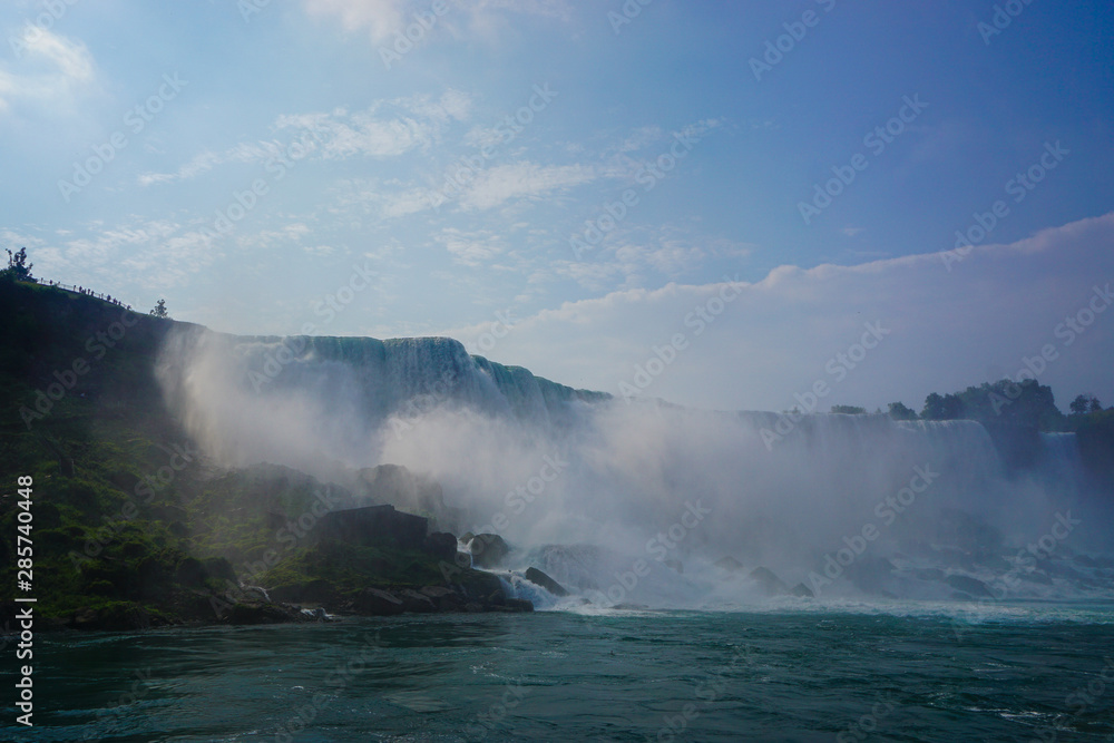 Wall mural Niagara Falls, NY: Sprays of mist rising from the American Falls, viewed from the deck of a tour boat in the Niagara Gorge.