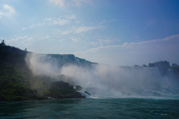 Niagara Falls, NY: Sprays of mist rising from the American Falls, viewed from the deck of a tour boat in the Niagara Gorge.