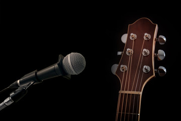 microphone and acoustic guitar on black background 