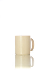 Cute cream color mug with white background. Mug for drinking hot drinks like coffee or tea.