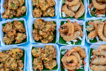Fried vegetables and shrimps deep-fried is a street food in local market in Thailand, closeup. Thai food