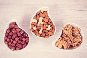 Different nuts and almonds containing vitamin, minerals and acids, nutritious eating concept