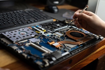 Fototapeta na wymiar Technician repairing broken laptop notebook computer