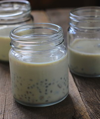 black sesame soy milk in glass on wood