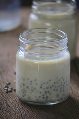 black sesame soy milk in glass on wood