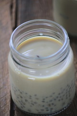 black sesame soy milk in glass on wood