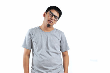 Young Asian man with grey t-shirt feeling exhausted