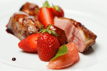 meat in sweet and sour sauce in strawberries and figs