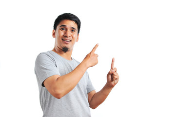 Handsome of happy smiling asian man pointing of a copyspace