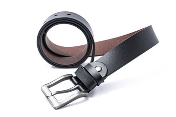 Black men's leather belts men's elegance trend on round shape with a white background. Fashion concept.