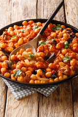 light and healthy vegan entree with chickpeas, eggplant, tomatoes, onions and spices. Traditional Middle Eastern Druze recipe closeup. vertical