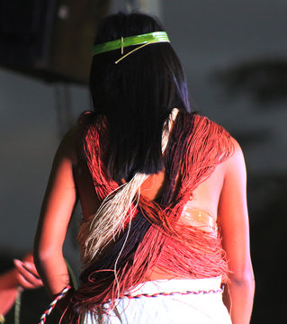 A Waorani Woman With Load Of Ropes Around Her Back And A Leaf Tied In Her Hair