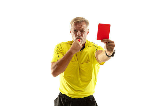 Referee showing a red card to a displeased football or soccer player while gaming isolated on white studio background. Concept of sport, rules violation, controversial issues, obstacles overcoming.