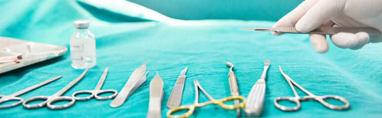 Hand holding surgical knife instruments and operating room,banner size