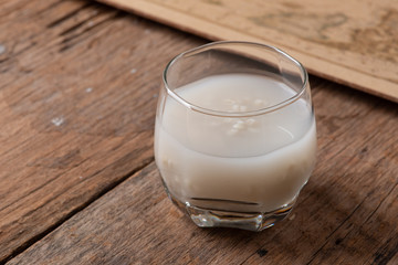 Barley water in glass with raw and cooked
