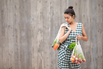 Young woman with white cotton Eco bag in hands. Lifestyle, zero waste concept