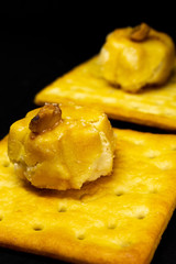 Cracker cookies on dark background.