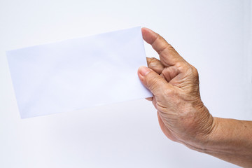 Senior woman's hand holding white envelope isolated on white background