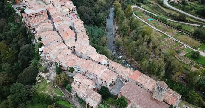 Aerial view of Castellfollit de la Roca, medieval Catalan hamlet on cliff on autumn day