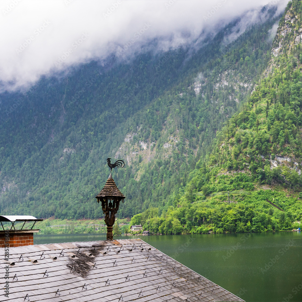 Sticker austrian landscape with wet roofs.