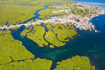 Town on the water and mangroves, top view. Coast of the island of Siargao. Tropical landscape.