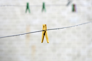 Fototapeta na wymiar Plastic clothesline with water drops after rain close up