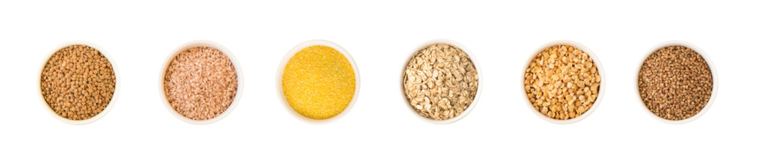 Top view of cereal and seeds in round ceramic plates. Lentil, rice, corn, oat flakes, pea, buckwheat isolated on white background