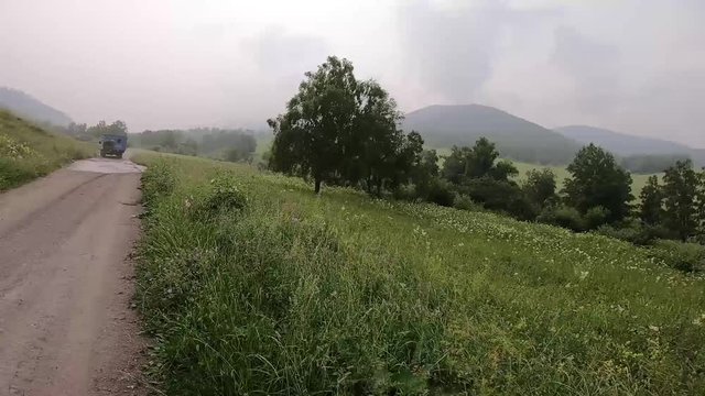 By car out of road. Car passes the road with stones, puddles and mud. Off the road travel on mountain.