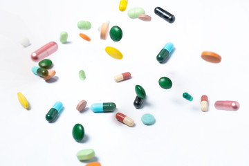 Colorful capsules and pills on white background. Concept of health