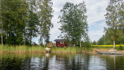 A typical scandinavian red wooden cottage on the shores of lake Saimaa in Finland - 2