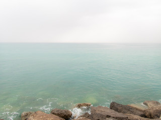 Fototapeta na wymiar The horizon on the moody Mediterranean sea in Tuscany near San Vincenzo - 1