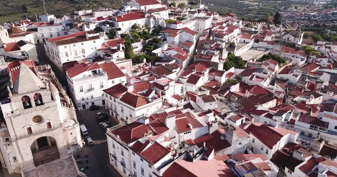 Picturesque aerial view of Elvas cityscape overlooking of Old Catholic Cathedral in sunny day, Portugal