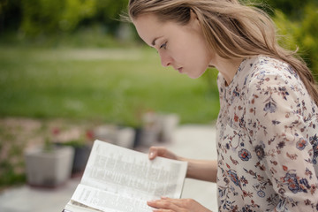 Christian worship and praise. A young woman is praying and worshiping in the evening.