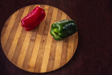 fresh red and green bell pepper on table