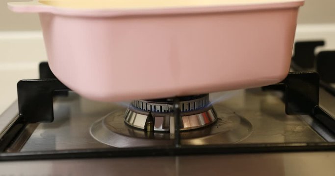 Turning on burner under ceramic pot for making compote :ASMR