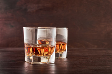 Glass of whiskey on a wooden table