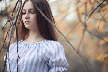 Young girl on a walk in the autumn