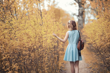 Young girl on a walk in the autumn