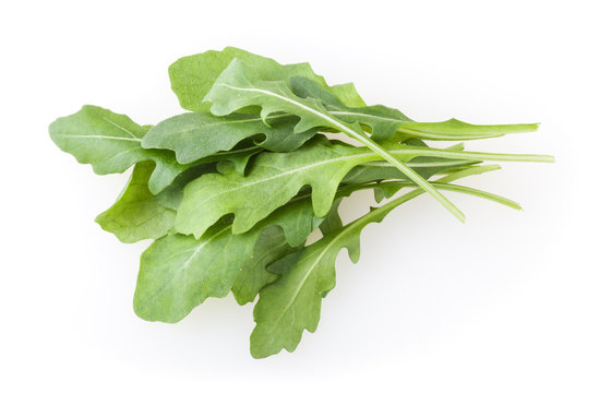 Heap of fresh arugula leaves isolated on white background