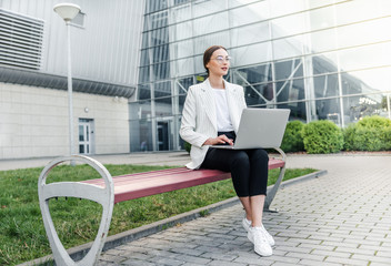 Successful businessman working at laptop. Business woman working. Sales woman working using her laptop while writing text. Businesswoman in glasses working on-line. Mobile technology.